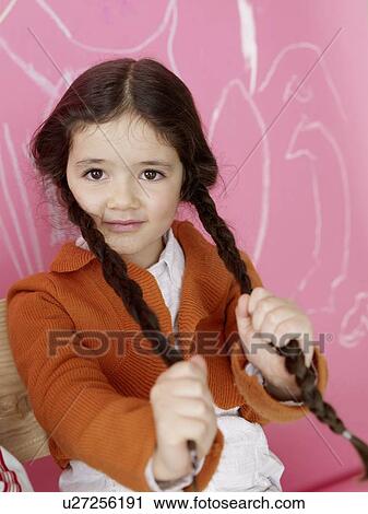 Girl pulling het plait View Large Photo Image Stock Image - Girl pulling het plait. Fotosearch