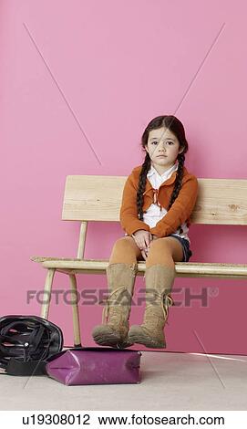 Stock Image - Girl sitting on a bench. Fotosearch