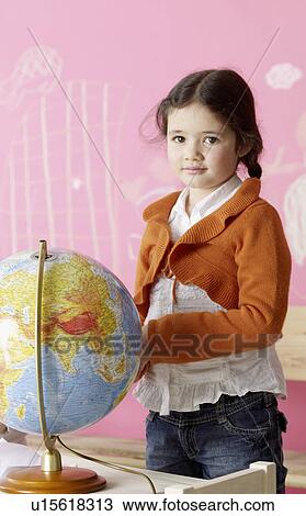 Stock Image - Girl with a globe. Fotosearch