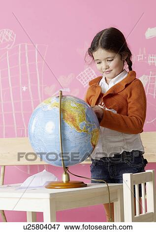 Stock Photo - Globe, girl in the background. Fotosearch