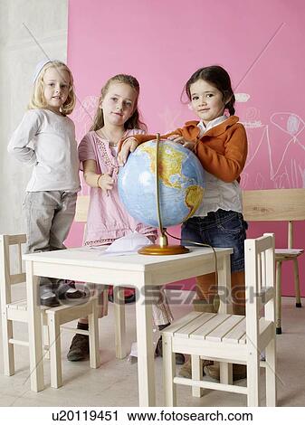 Three girls with a globe View Large Photo Image Stock Image - Three girls with a globe. Fotosearch