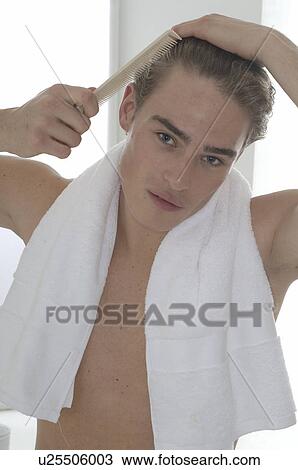 Man is combing his hair View Large Photo Image Stock Image - Man is combing his hair. Fotosearch