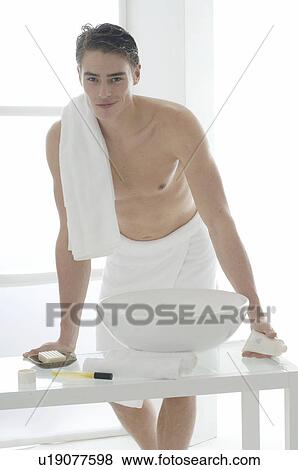 Man standing in front of a washbowl View Large Photo Image Stock Photo - Man standing in front of a washbowl. Fotosearch
