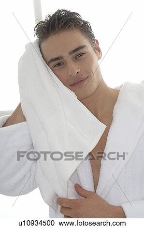 Stock Image - Man wearing bathrobe with towel. Fotosearch