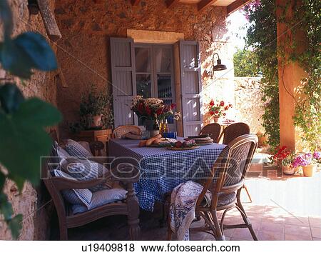 Stock Photo - Cosy summer table on the terrace. Fotosearch