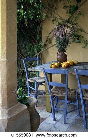 Stock Image - Mediterranean seat with blue chairs. Fotosearch