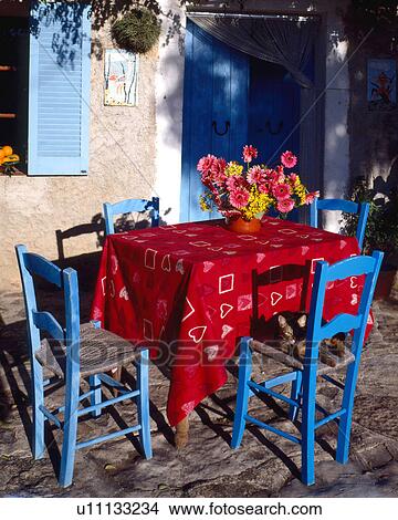 Picture - Table and blue chairs - southern terrace. Fotosearch
