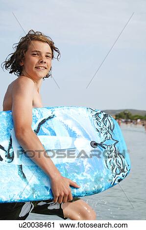 Stock Image - Boy holding a kickboard. Fotosearch