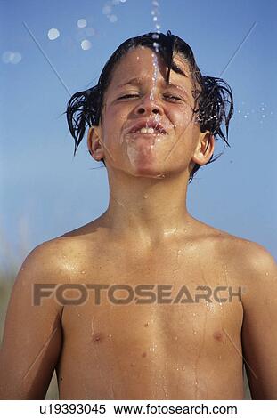 Stock Photography - Boy is spitting water. Fotosearch