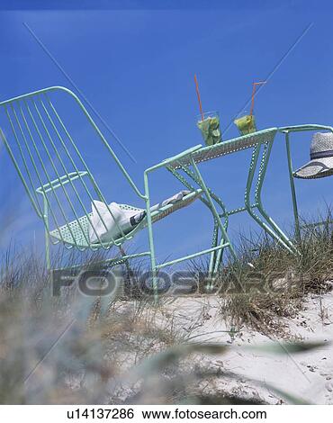 Stock Photograph - On the beach: a place with two caipirinhas. Fotosearch