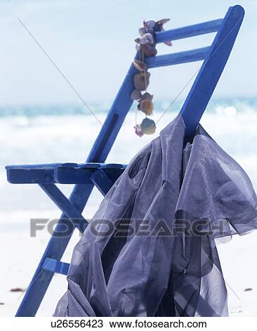 Stock Image - On the beach: blue folding chair. Fotosearch