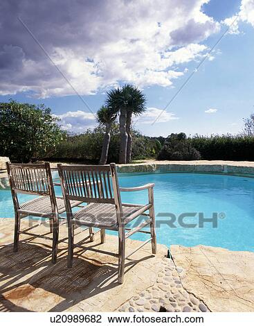 Two chairs at the swimming pool View Large Photo Image Stock Image - Two chairs at the swimming pool. Fotosearch