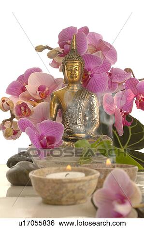 Stock Photograph - Bouqet of ochids an a buddha. Fotosearch