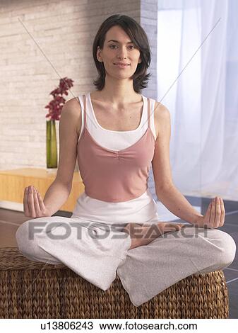 Woman sitting cross-legged doing yoga exercise View Large Photo Image Stock Image - Woman sitting cross-legged doing yoga exercise. Fotosearch