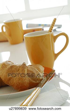 Stock Photo - a cup and a croissant. Fotosearch