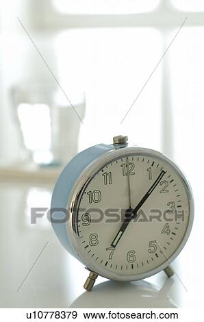Stock Photo - Blue alarmclock. Fotosearch
