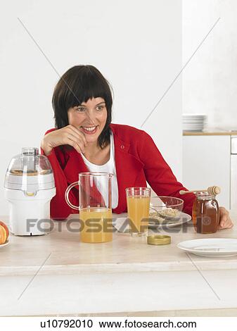 Woman at breakfast table View Large Photo Image Stock Image - Woman at breakfast table. Fotosearch
