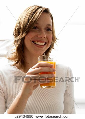 Woman drinking juice View Large Photo Image Stock Image - Woman drinking juice. Fotosearch