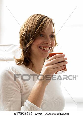 Woman drinking juice View Large Photo Image Stock Photography - Woman drinking juice. Fotosearch