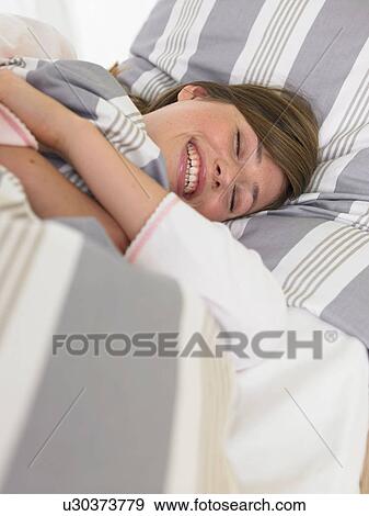 Stock Photo - Woman in bed. Fotosearch