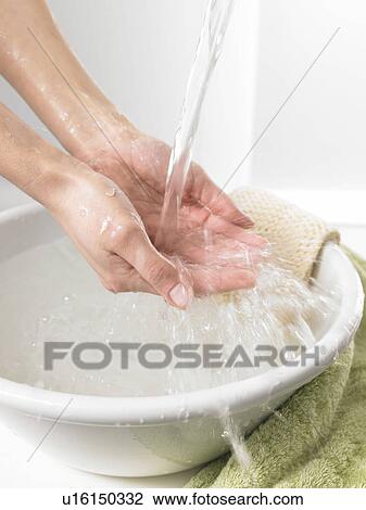 Stock Image - woman washing her hands. Fotosearch