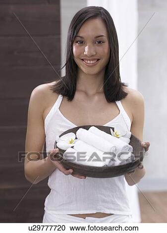 euro-asian woman offeirng white towels View Large Photo Image Stock Image - euro-asian woman offeirng white towels. Fotosearch