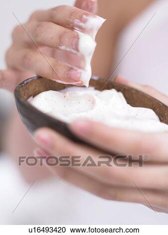 Stock Image - natural cosmetics in a coconut shell. Fotosearch