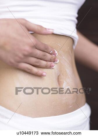 Stock Image - slim belly, creme massage. Fotosearch