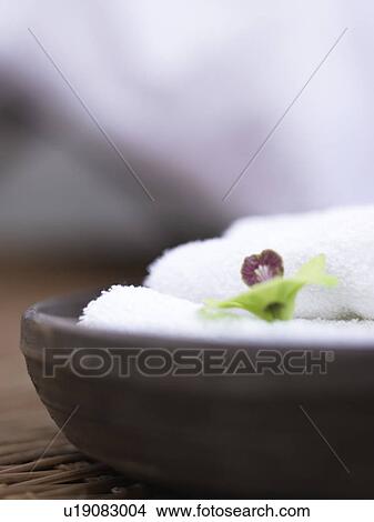 Picture - towel and orchid blossom. Fotosearch