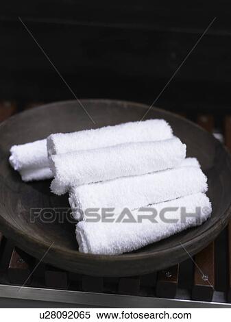 Stock Photography - White towels in a black dish. Fotosearch