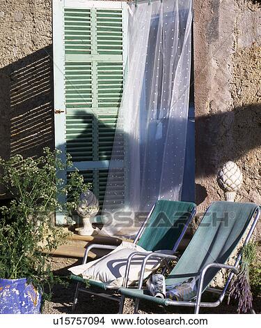 Picture - deck chair on a sunny veranda. Fotosearch