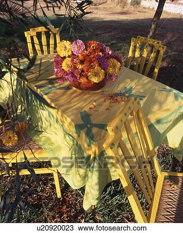 Stock Image - garden table with flower arrangement. Fotosearch