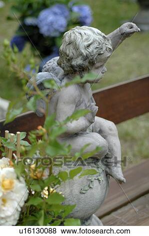 Stock Photo - stone putto und rose bush. Fotosearch