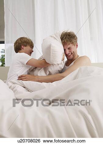 father and son's pillow fight View Large Photo Image Stock Photograph - father and son's pillow fight. Fotosearch
