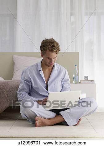 Stock Image - freelance working in pyjamas. Fotosearch