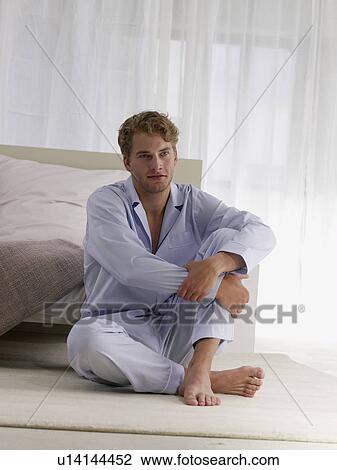 Stock Image - young man in blue pyjamas. Fotosearch