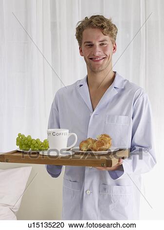 Stock Image - young man in blue pyjamas. Fotosearch