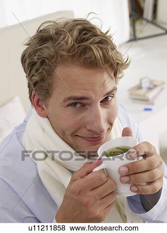 Stock Photo - young man sick in bed. Fotosearch