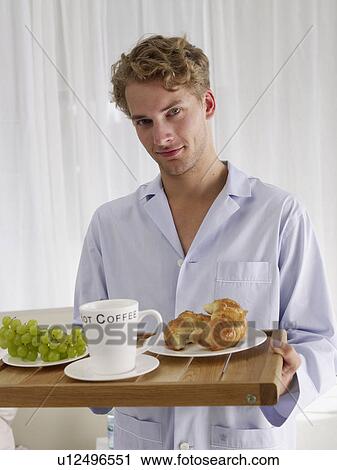 Stock Image - young man with breakfast. Fotosearch