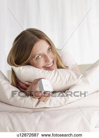 Stock Photo - young woman in bed. Fotosearch