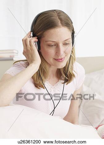 young woman listening music View Large Photo Image Stock Image - young woman listening music. Fotosearch