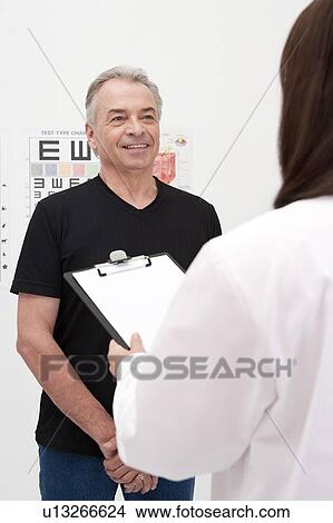 Picture - Domestic Life, a senior man consulting with the doctor. Fotosearch