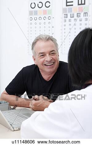 Domestic Life, a senior man consulting the doctor View Large Photo Image Stock Photograph - Domestic Life, a senior man consulting the doctor. Fotosearch