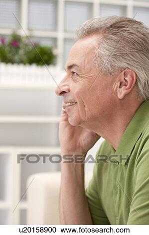 Domestic Life, a senior man looking away with smile, talking on phone View Large Photo Image Stock Image - Domestic Life, a senior man looking away with smile, talking on phone. Fotosearch