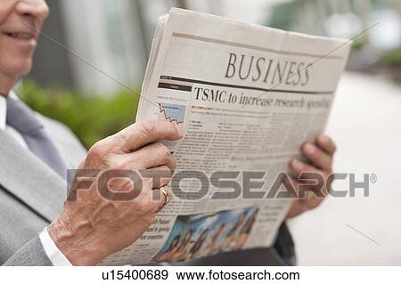 Stock Photo - Senior businessman reading newspaper. Fotosearch
