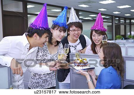 Colleagues wearing headwear and toasting for celebrating View Large Photo Image Stock Photo - Colleagues wearing headwear and toasting for celebrating. Fotosearch