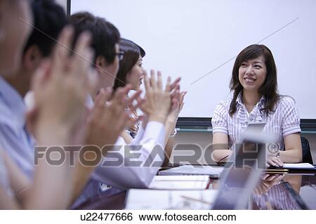 Stock Photograph - People clapping for success together. Fotosearch