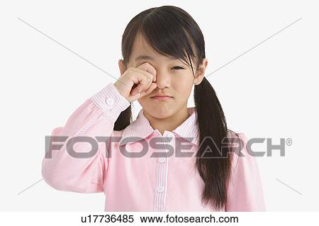Stock Photography - Little girl putting hand on one eye and puckering. Fotosearch