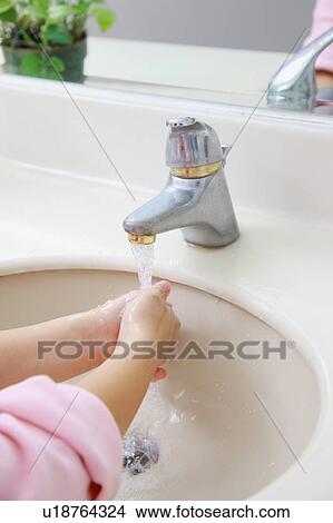 Picture - Little girl washing hands under faucet. Fotosearch