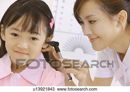 Young nurse making body care for little girl View Large Photo Image Stock Image - Young nurse making body care for little girl. Fotosearch
